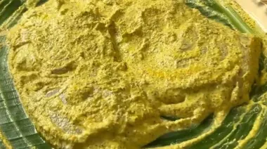 Bhetki Paturi wrapped in banana leaves, coated with mustard paste